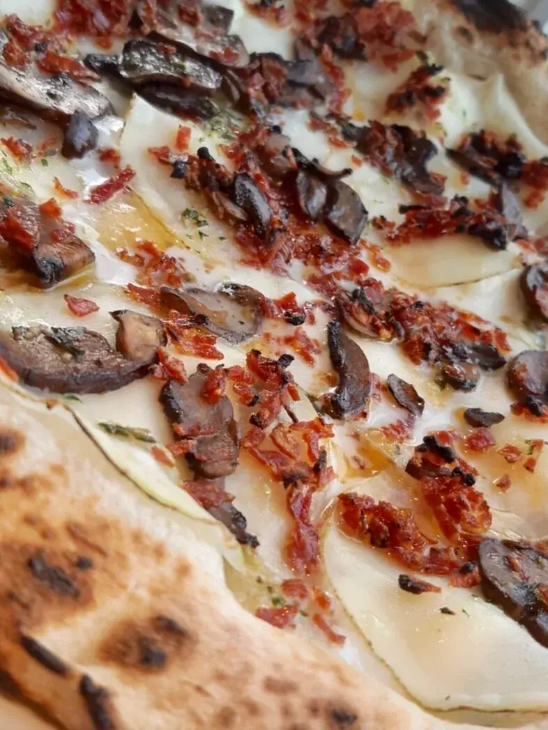 PIZZA of the Month Thinly sliced potatoes with cremini mushrooms and crispy local water buffalo salami, smothered in Ontario fior di latte