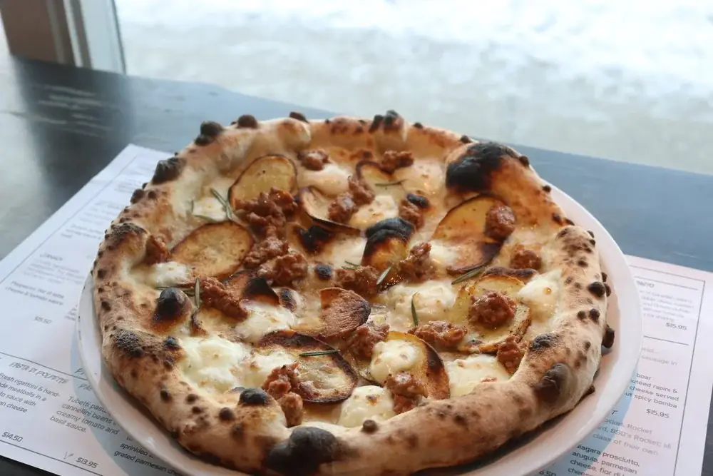 Roasted potatoes, wild boar and truffle oil with fior di latte cheese.