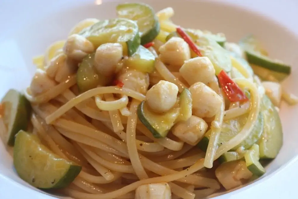 Pan cooked scallops, zucchini and cherry tomatoes served with linguine pasta.
