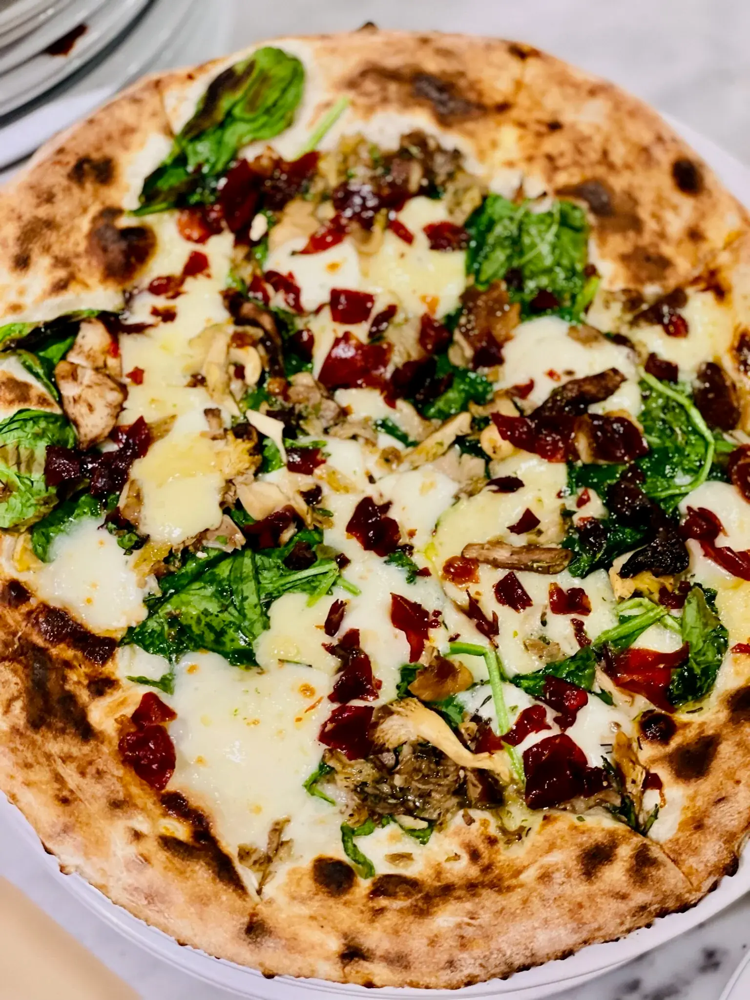 A glorious combination of spinach, deep fried speck, wild mushrooms, garlic oil, truffle oil, Fior di latte, and truffle cheese ($17.50).