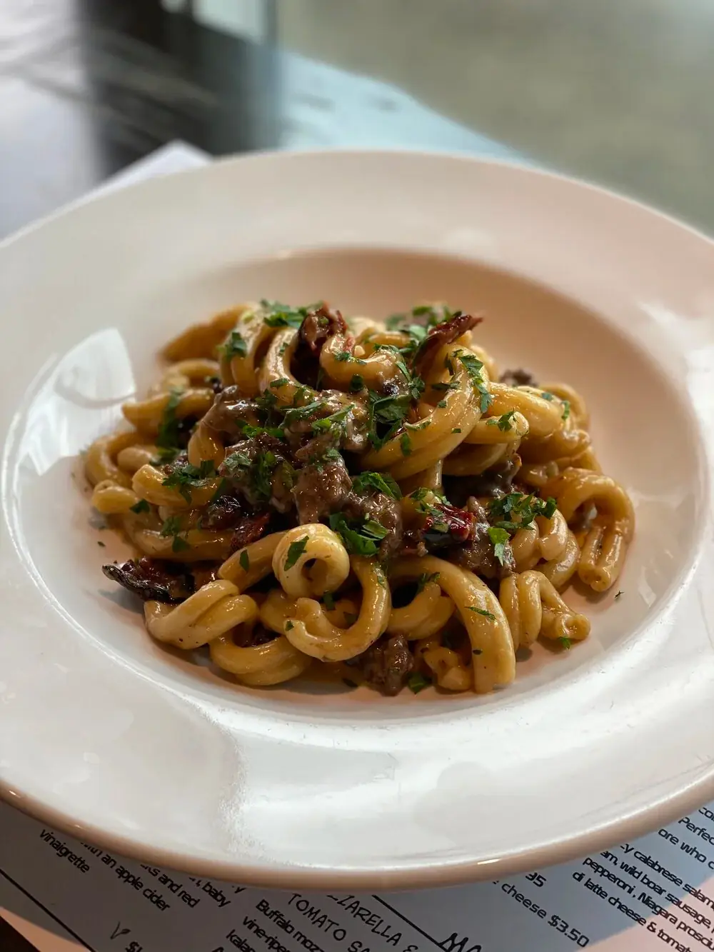 Gemelli pasta, mangalitsa sausages, pan fried leeks, garlic, sundried tomatoes, raisins in a red wine, parmigiano and cream sauce.