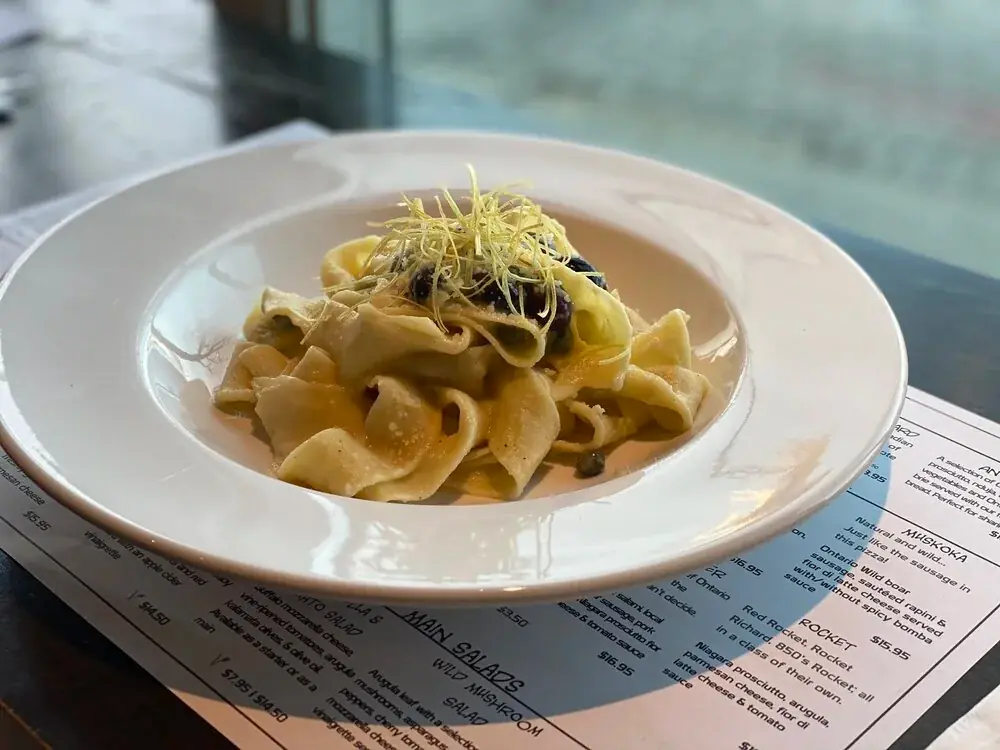 PASTA of the Month   Parpadelle pasta with crema di cavolfiore, kalamata olives, capers and fried leeks.