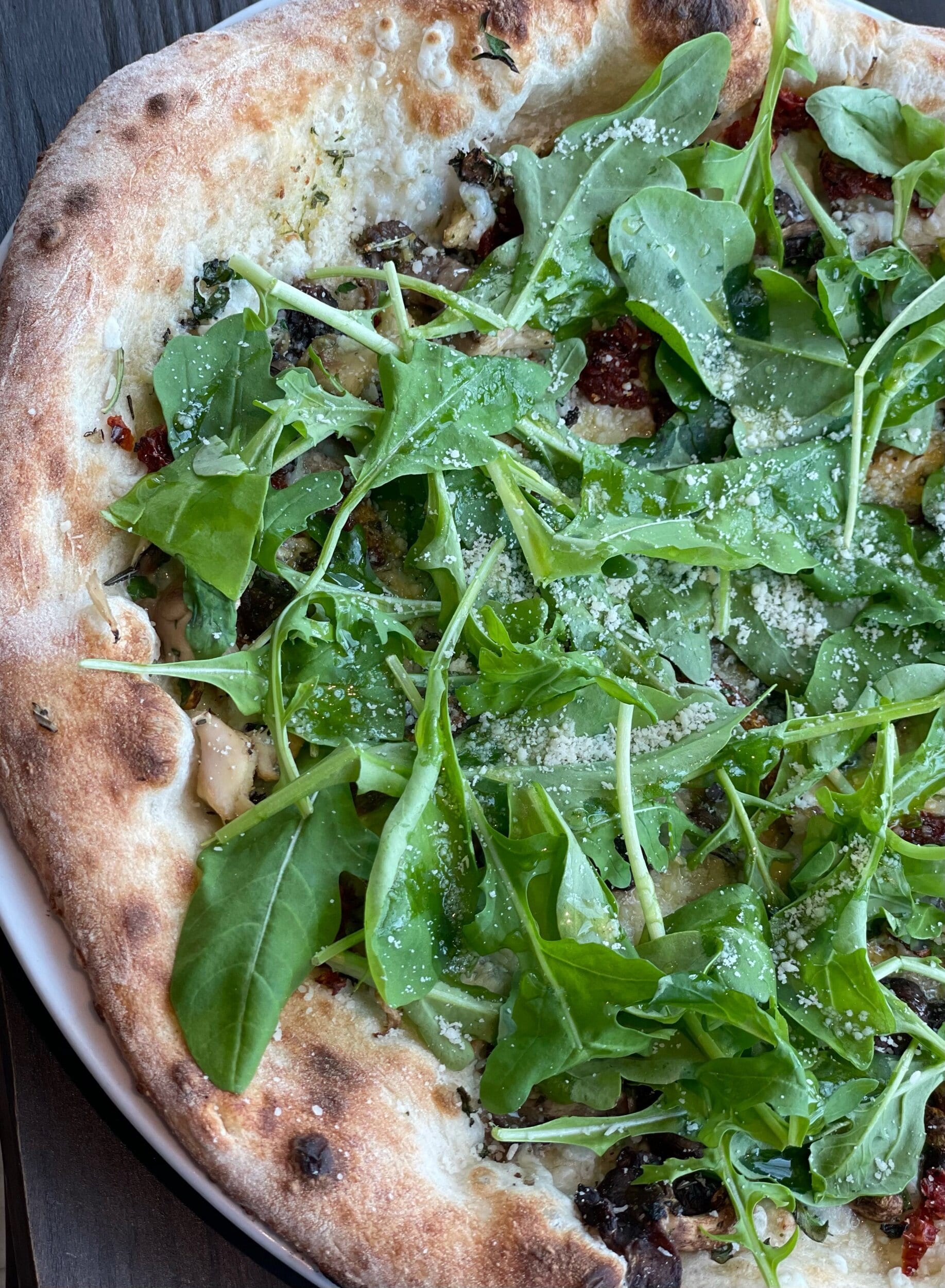 Mixed local wild mushrooms, Sun-dried tomatoes, Garlic oil, Mozzarella cheese, Local arugula and Parmesan.